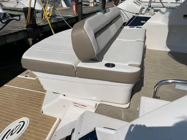 Slide: The Image of 2018 Regal 35 Sport Coupe boat seating area with beige and white upholstery. - 33
