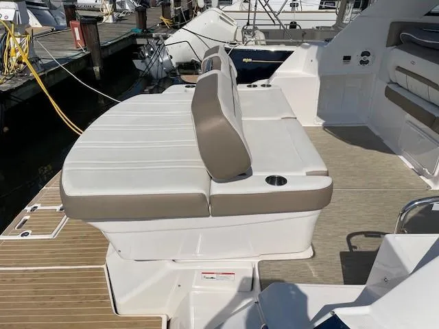 Slide: The Image of 2018 Regal 35 Sport Coupe boat interior with cushioned seating and cup holders. - 34