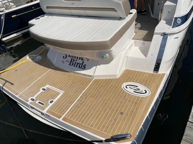 Slide: The Image of 2018 Regal 35 Sport Coupe boat with teak swim platform and cushioned seating. - 35