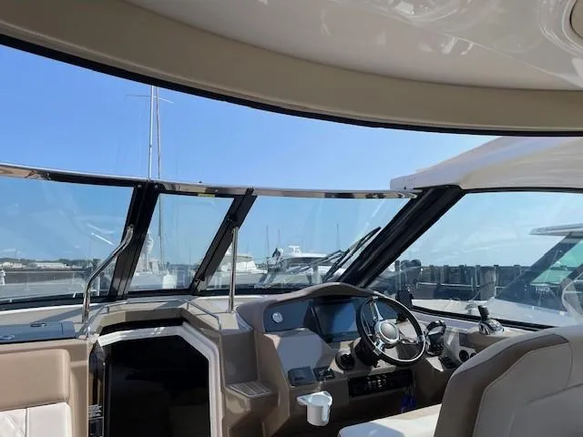 Slide: The Image of Interior view of 2018 Regal 35 Sport Coupe yacht cockpit with steering wheel. - 38