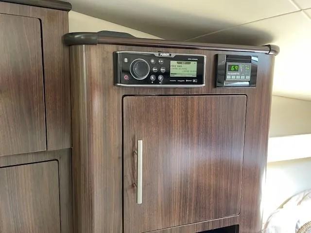 Slide: The Image of Control panel in 2018 Regal 35 Sport Coupe with wood finish cabinetry. - 46