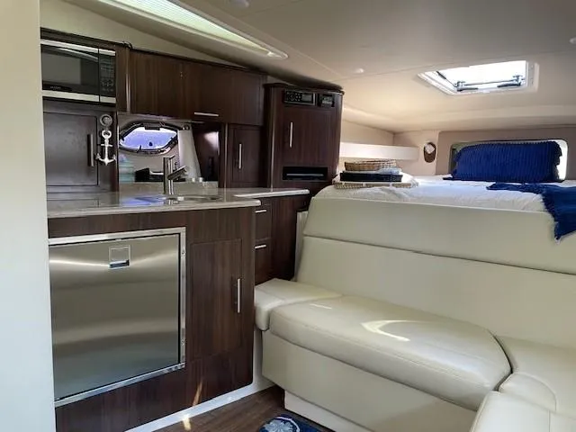 Slide: The Image of Interior of 2018 Regal 35 Sport Coupe with modern kitchen and cozy seating area. - 48