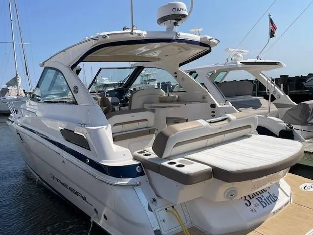 Slide: The Image of 2018 Regal 35 Sport Coupe yacht docked, featuring spacious seating and modern design. - 5