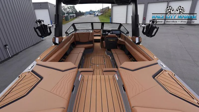 Slide: The Image of 2025 Nautique Super Air Nautique G25 interior with tan seating and sleek design. - 16