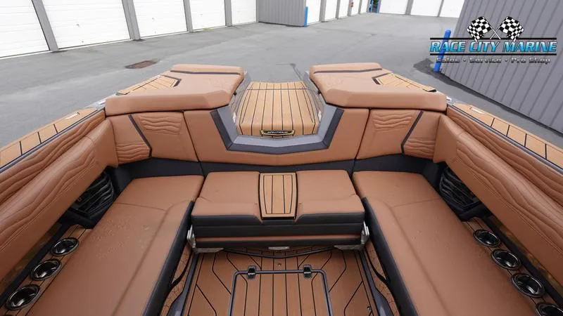 Slide: The Image of 2025 Nautique Super Air Nautique G25 interior with luxurious tan seating and sleek design. - 17