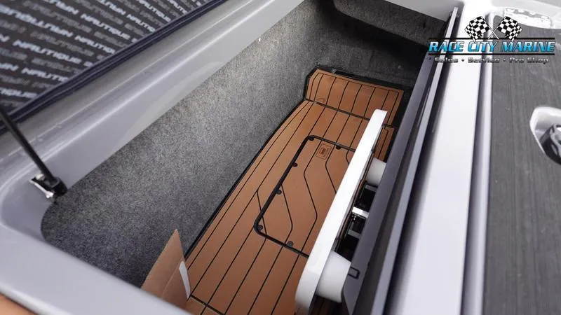 Slide: The Image of 2025 Nautique Super Air Nautique G25 storage compartment with teak flooring. - 20