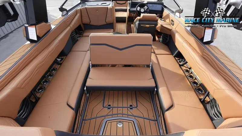 Slide: The Image of 2025 Nautique Super Air Nautique G25 interior with luxurious tan seating and sleek design. - 22