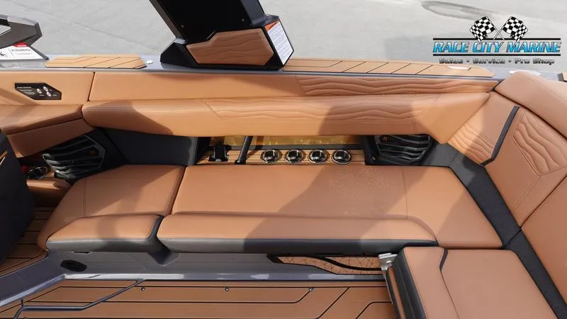 Slide: The Image of 2025 Nautique Super Air Nautique G25 interior with tan leather seating and sleek design. - 23