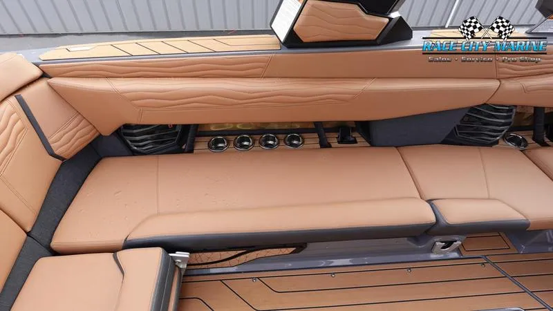 Slide: The Image of Luxurious interior of 2025 Nautique Super Air Nautique G25 boat with tan leather seating. - 24