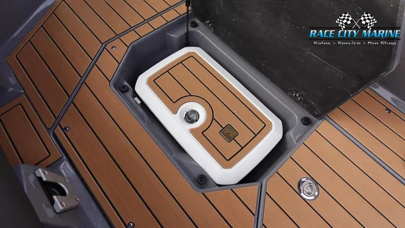 Slide: The Image of 2025 Nautique Super Air Nautique G25 storage compartment with teak flooring. - 31