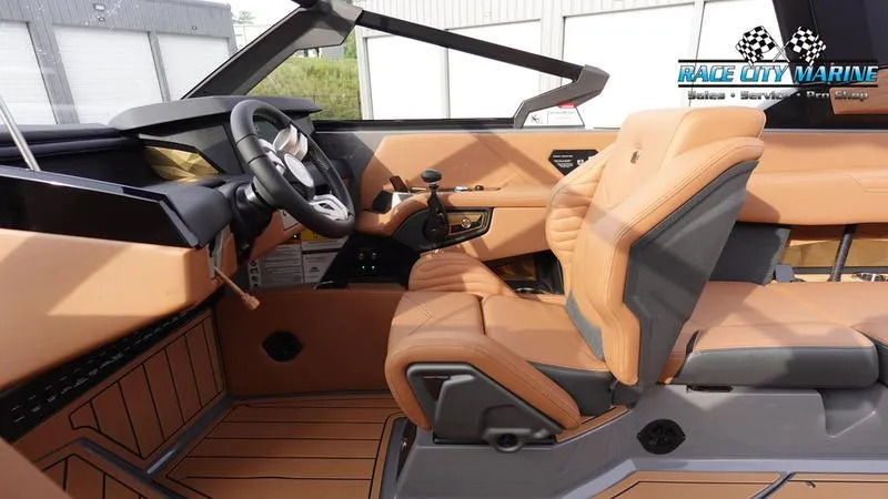 Slide: The Image of 2025 Nautique Super Air Nautique G25 interior with tan leather seats and modern dashboard. - 33