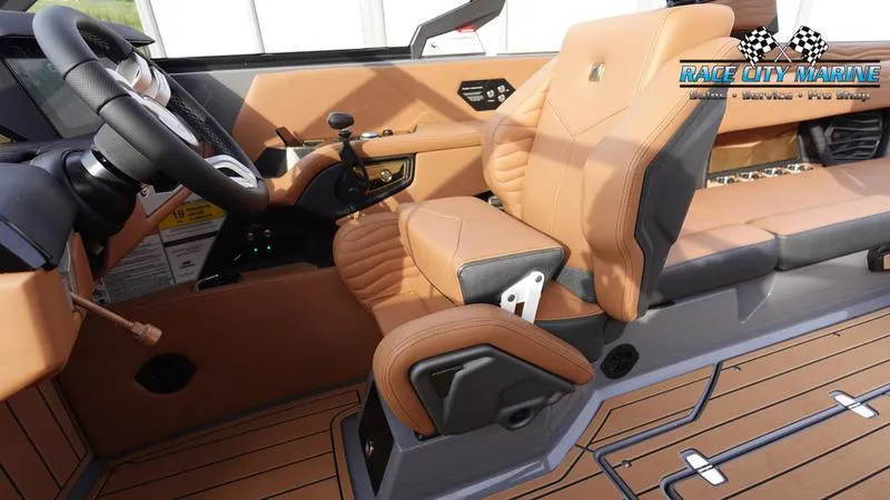 Slide: The Image of 2025 Nautique Super Air Nautique G25 interior with tan leather seats and modern dashboard. - 34