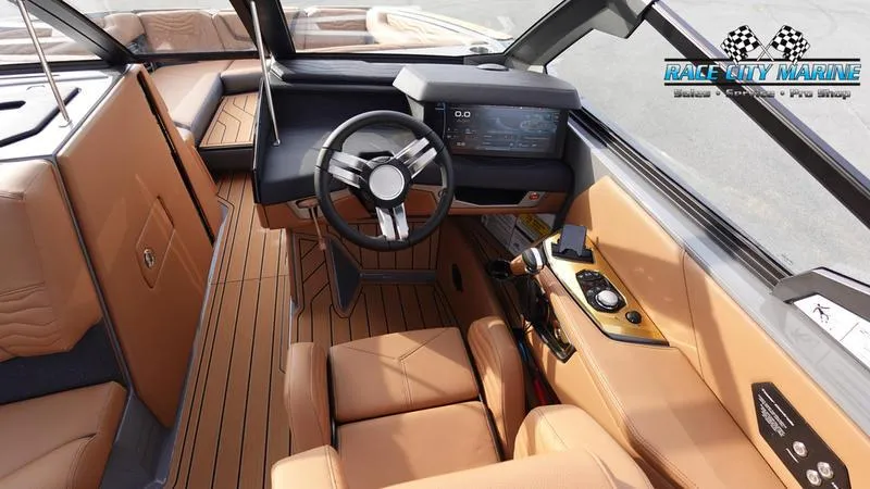 Slide: The Image of 2025 Nautique Super Air Nautique G25 interior with tan leather seats and modern dashboard. - 45