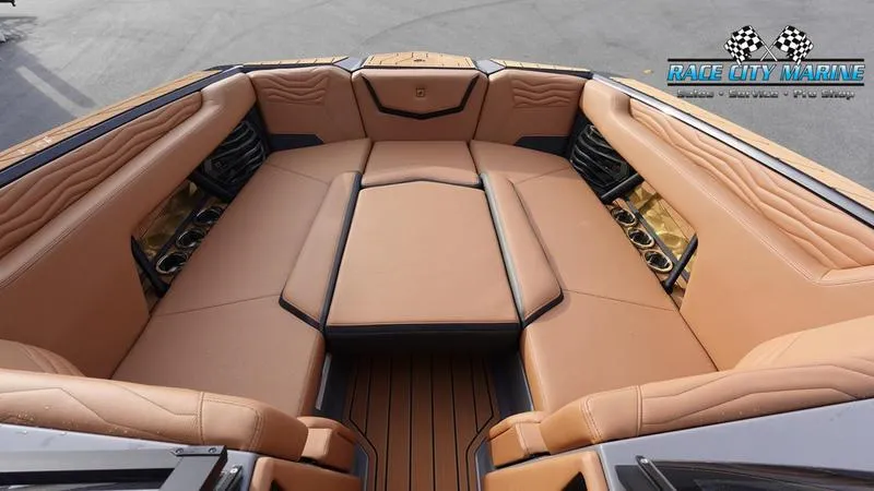 Slide: The Image of 2025 Nautique Super Air Nautique G25 boat interior with tan leather seating. - 47