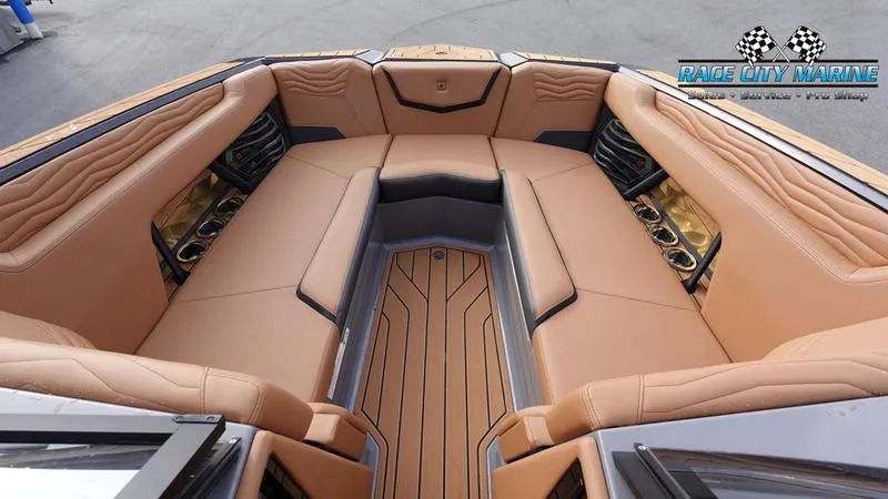 Slide: The Image of Luxurious interior of 2025 Nautique Super Air Nautique G25 boat with tan seating. - 48