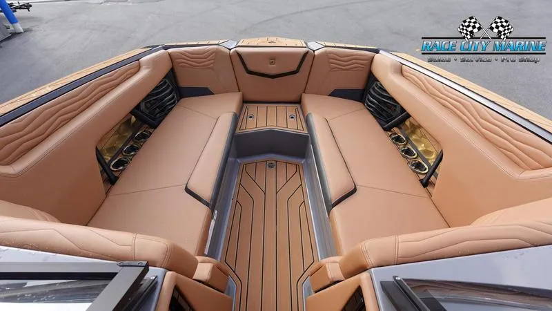 Slide: The Image of Luxurious interior of 2025 Nautique Super Air Nautique G25 boat with tan seating. - 49