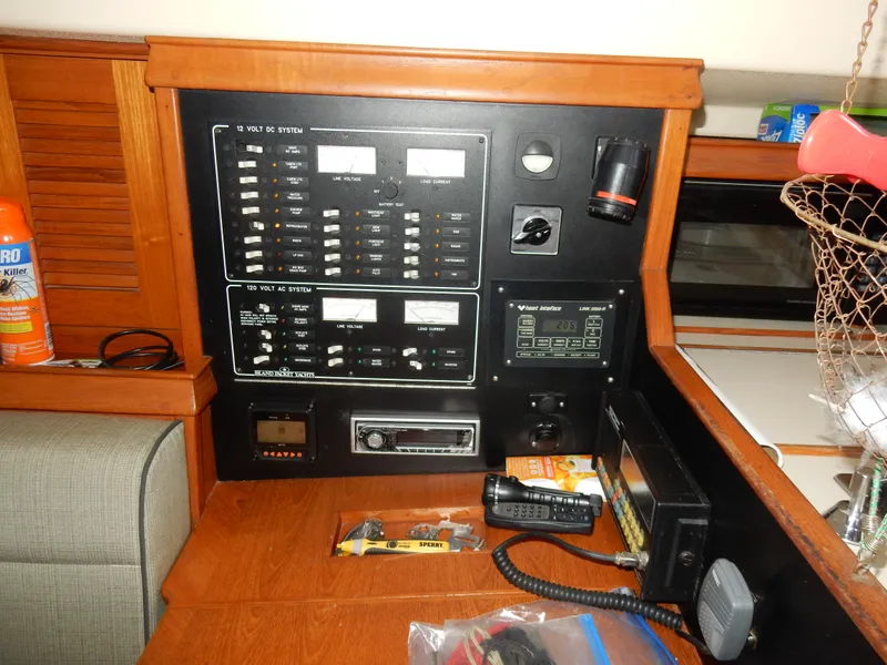 Slide: The Image of Electrical control panel on a 1997 Island Packet 40 sailboat, featuring various switches and equipment. - 19