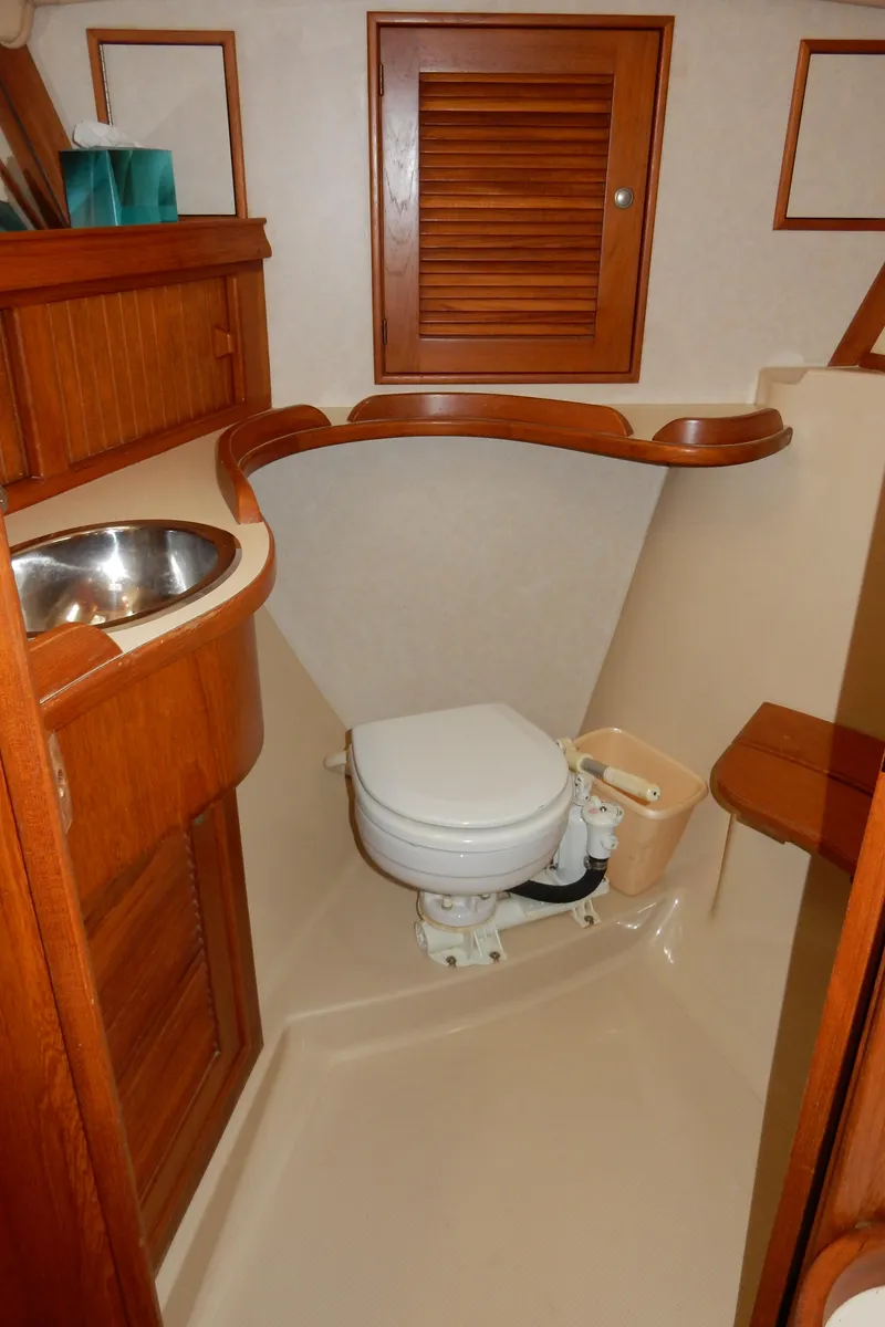Slide: The Image of 1997 Island Packet 40 yacht bathroom with wooden cabinetry and compact design. - 31