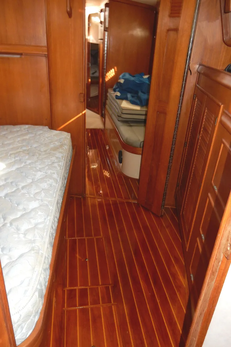 Slide: The Image of Interior of 1997 Island Packet 40 sailboat with wooden flooring and cozy cabin layout. - 32