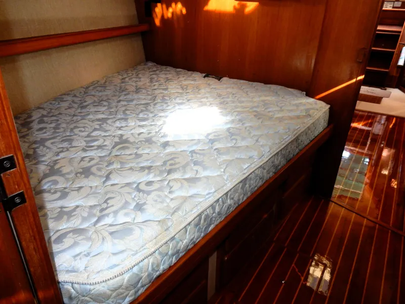 Slide: The Image of Cozy cabin bed in 1997 Island Packet 40 sailboat with wooden interior. - 33