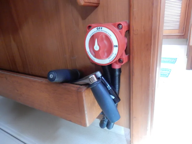 Slide: The Image of Battery switch on 1997 Island Packet 40 sailboat, mounted on wooden panel. - 36
