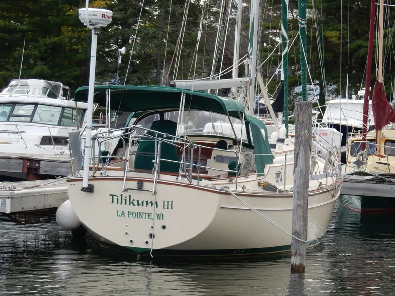 Slide: The Image of Island Packet 40 sailboat, 1997 model, docked at marina with green canopy. - 4