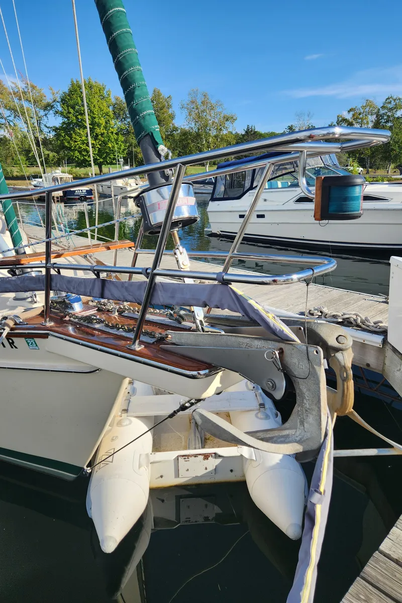 Slide: The Image of 1997 Island Packet 40 sailboat docked, featuring bow and anchor details. - 49