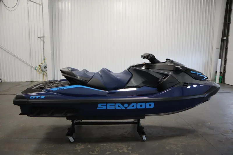 Slide: The Image of 2025 Sea-Doo GTX 230 jet ski with tech, audio, iDF, iBR features in a showroom. - 3