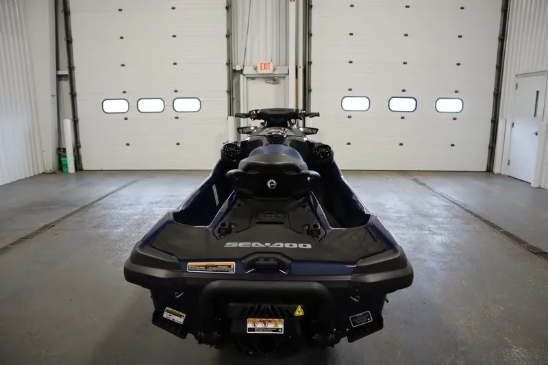 Slide: The Image of 2025 Sea-Doo GTX™ 230 in garage, rear view, showcasing sleek design and features. - 4