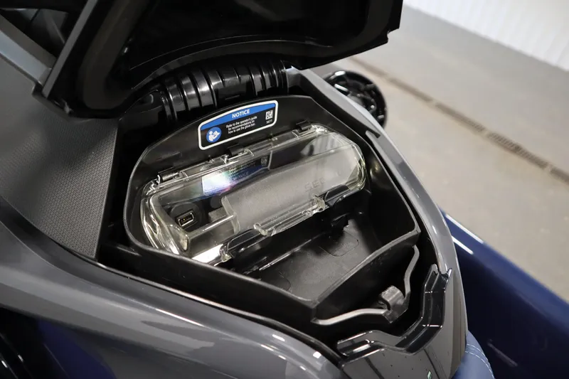 Slide: The Image of 2025 Sea-Doo GTX™ 230 storage compartment with tech features and audio system. - 8