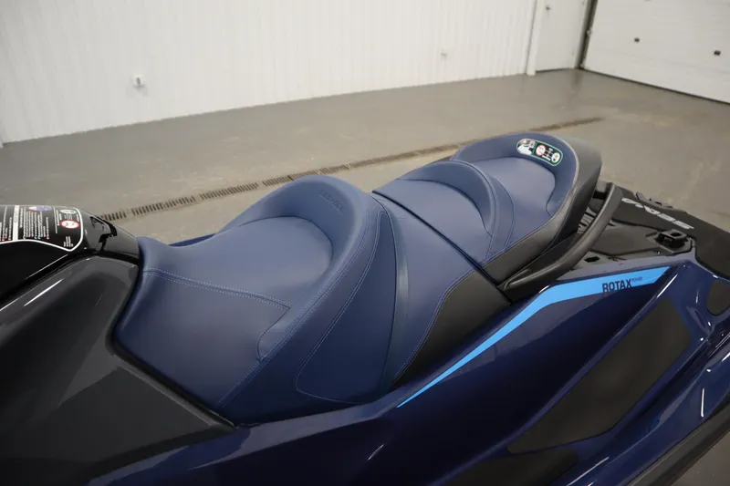 Slide: The Image of 2025 Sea-Doo GTX™ 230 jet ski with blue seating, featuring Tech, Audio, iDF, and iBR systems. - 9