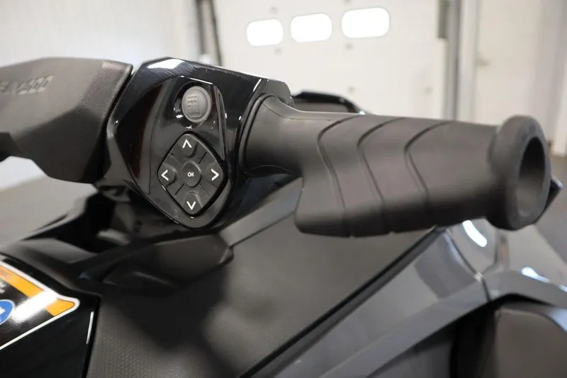 Slide: The Image of Close-up of 2025 Sea-Doo GTX 170 handlebar controls in a garage setting. - 13