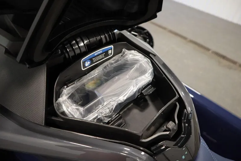 Slide: The Image of 2025 Sea-Doo GTX 170 storage compartment with protective cover, showcasing interior design. - 16