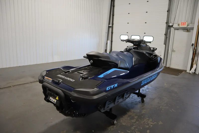 Slide: The Image of 2025 Sea-Doo GTX 170 jet ski with tech, audio, iDF, and iBR features in a garage. - 3