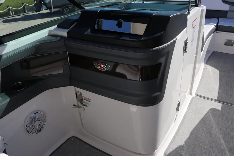 Slide: The Image of Interior view of 2019 Chaparral 297 SSX boat, featuring sleek dashboard and seating area. - 12