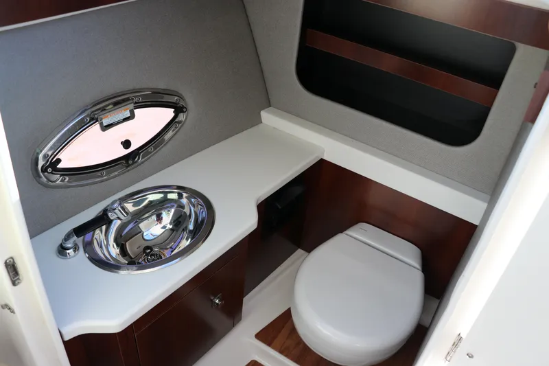 Slide: The Image of 2019 Chaparral 297 SSX boat bathroom with sink and toilet. - 14