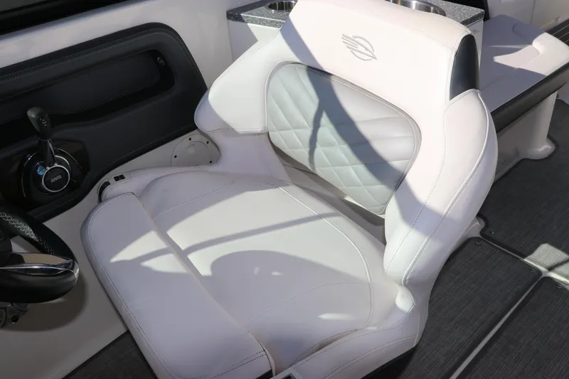 Slide: The Image of 2019 Chaparral 297 SSX boat interior with white leather seat and steering controls. - 16