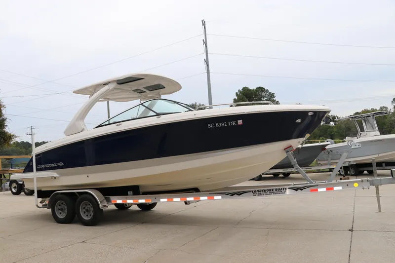 Slide: The Image of 2019 Chaparral 297 SSX boat on trailer in outdoor setting. - 2