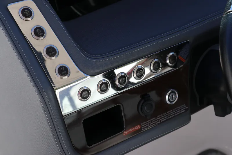 Slide: The Image of Control panel of 2019 Chaparral 297 SSX boat with metallic buttons and switches. - 20