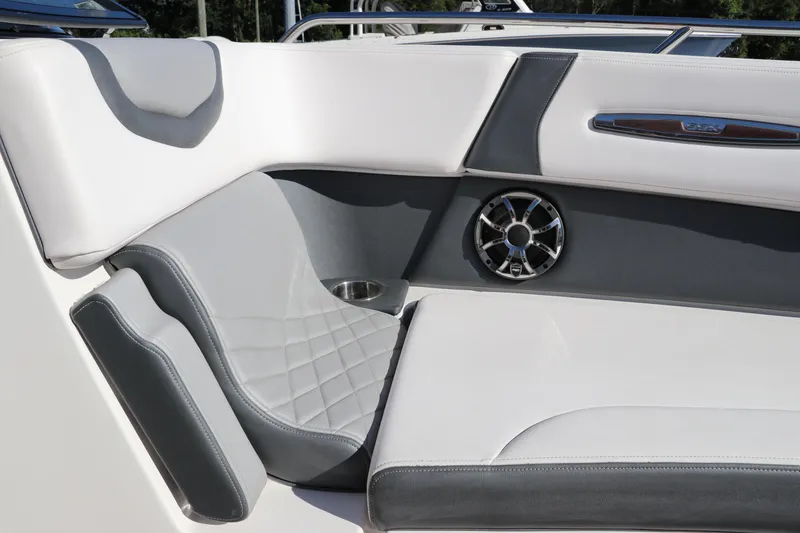 Slide: The Image of 2019 Chaparral 297 SSX boat interior with gray and white seating, speaker, and cup holder. - 29