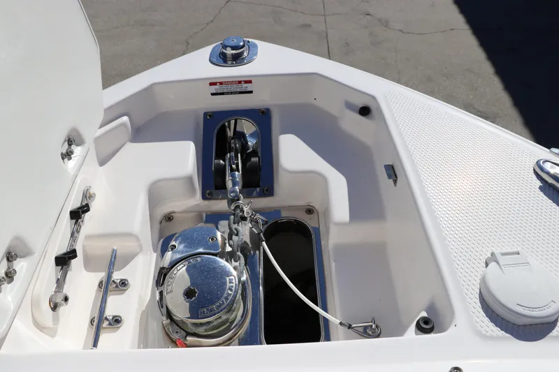 Slide: The Image of 2019 Chaparral 297 SSX boat anchor compartment with chrome fittings. - 33