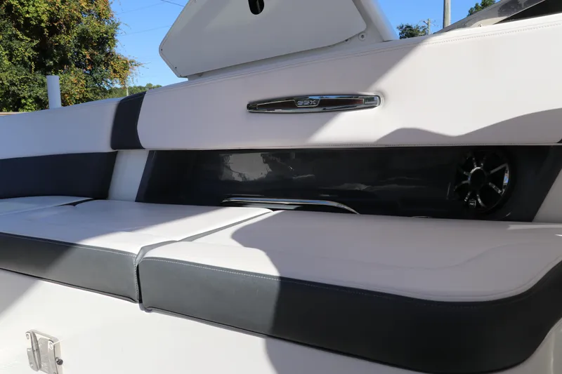 Slide: The Image of 2019 Chaparral 297 SSX boat interior seating with speaker and storage compartment. - 5