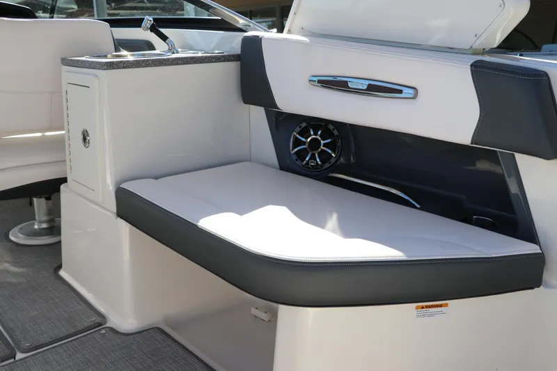 Slide: The Image of 2019 Chaparral 297 SSX boat interior with cushioned seating and built-in speaker. - 6