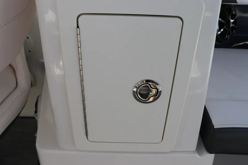 Slide: The Image of 2019 Chaparral 297 SSX boat storage compartment with chrome handle. - 8
