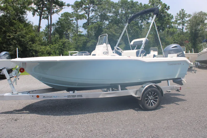 Slide: The Image of 2025 Tidewater 180 CC Adventure boat on trailer, parked outdoors. - 1