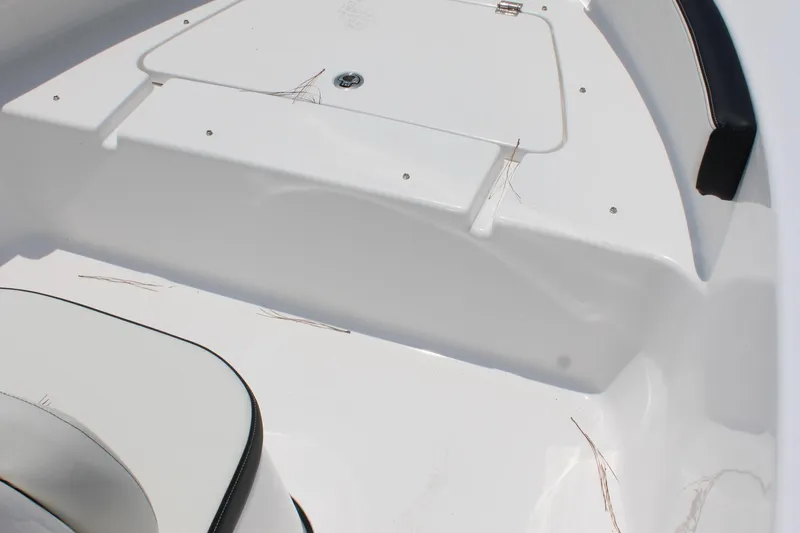 Slide: The Image of 2025 Tidewater 180 CC Adventure boat interior with white seating and storage compartment. - 18