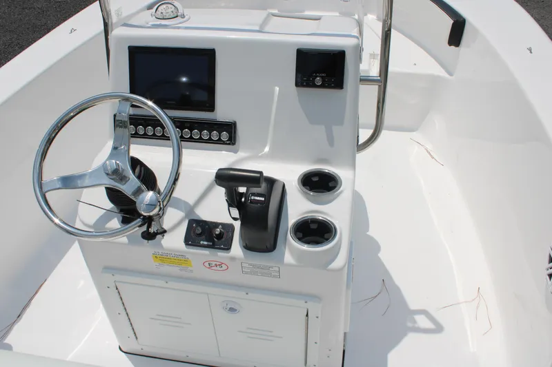 Slide: The Image of 2025 Tidewater 180 CC Adventure boat console with steering wheel and controls. - 7