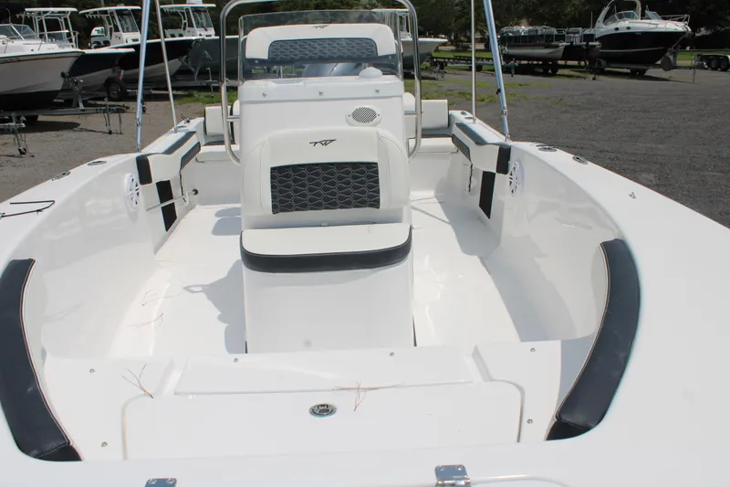 Slide: The Image of 2025 Tidewater 180 CC Adventure boat interior, featuring sleek white design and spacious seating. - 9