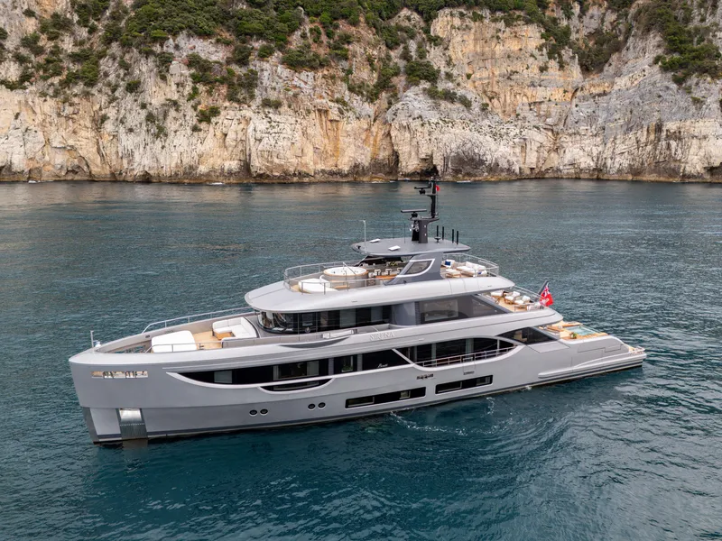 Slide: The Image of 2025 Benetti Oasis 34M yacht cruising near rocky coastline. - 13