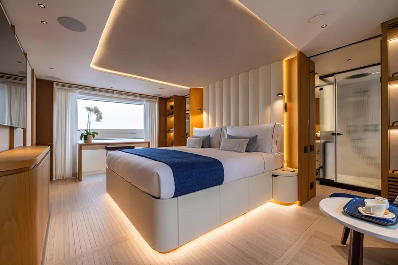 Slide: The Image of Luxurious bedroom interior of 2025 Benetti Oasis 34M yacht with modern design and ambient lighting. - 34